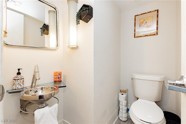 bathroom featuring sink and toilet