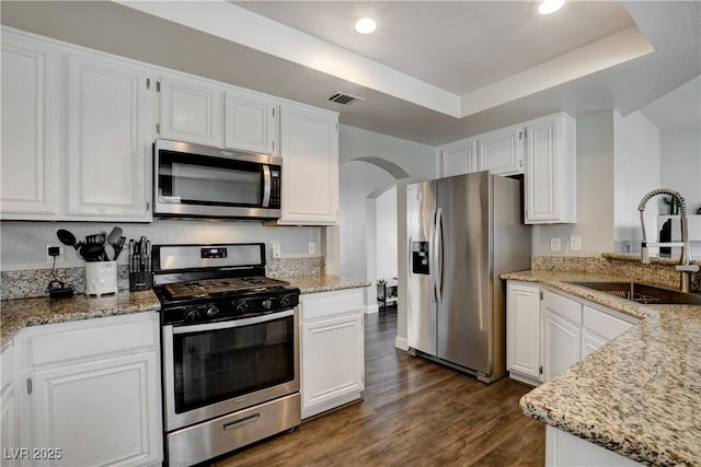 3320 Haven Beach Way, Las Vegas, NV 89117 - kitchen featuring appliances with stainless steel finishes, a sink, dark wood-type flooring, white cabinets, and recessed lighting