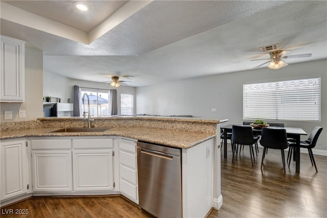 3320 Haven Beach Way, Las Vegas, NV 89117 - kitchen with stainless steel dishwasher, a sink, a ceiling fan, white cabinetry, and wood finished floors