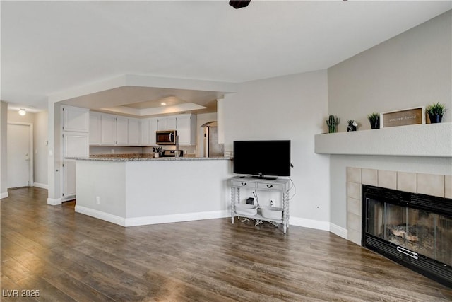 3320 Haven Beach Way, Las Vegas, NV 89117 - living area featuring wood finished floors, baseboards, and a tiled fireplace