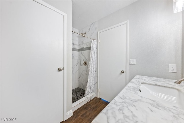 3320 Haven Beach Way, Las Vegas, NV 89117 - bathroom featuring a marble finish shower, wood finished floors, and vanity