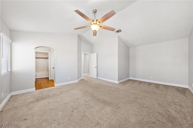 3320 Haven Beach Way, Las Vegas, NV 89117 - unfurnished bedroom featuring carpet flooring, arched walkways, lofted ceiling, ceiling fan, and ensuite bathroom