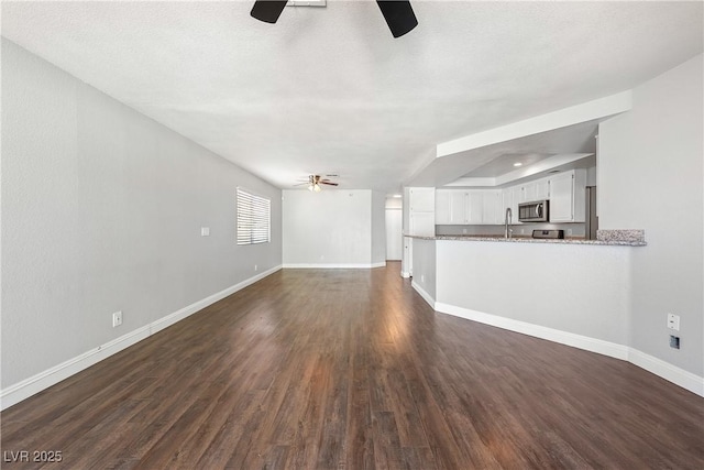 3320 Haven Beach Way, Las Vegas, NV 89117 - unfurnished living room featuring ceiling fan and dark wood finished floors