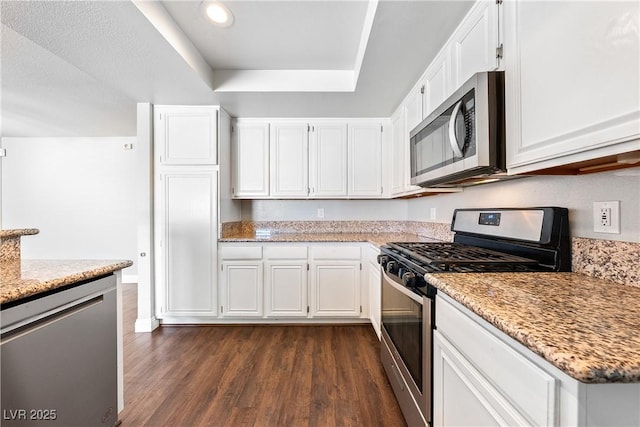 3320 Haven Beach Way, Las Vegas, NV 89117 - kitchen featuring appliances with stainless steel finishes, dark wood finished floors, white cabinetry, and recessed lighting