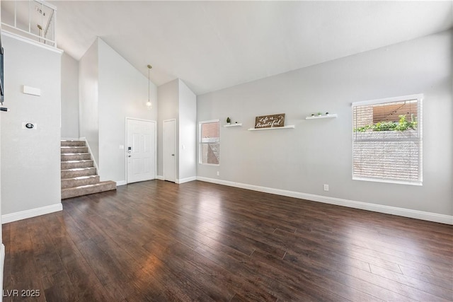 3320 Haven Beach Way, Las Vegas, NV 89117 - unfurnished living room with dark wood-type flooring, stairway, and high vaulted ceiling