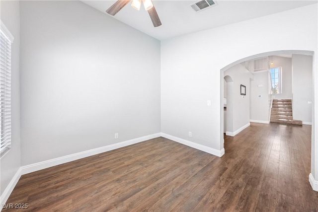 3320 Haven Beach Way, Las Vegas, NV 89117 - unfurnished room featuring a ceiling fan, dark wood-type flooring, arched walkways, and stairs