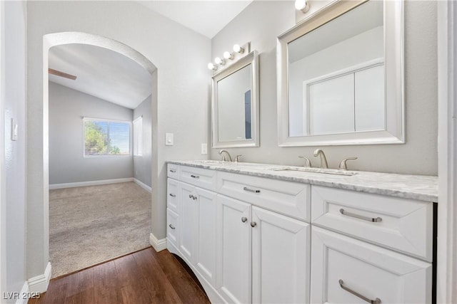 3320 Haven Beach Way, Las Vegas, NV 89117 - bathroom with double vanity, vaulted ceiling, and wood finished floors