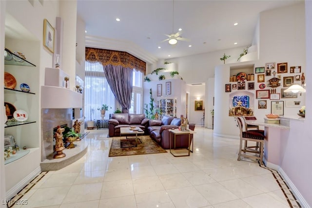 living room with light tile patterned floors, a towering ceiling, and ceiling fan