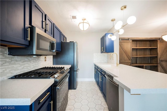 kitchen with blue cabinetry, decorative backsplash, sink, and appliances with stainless steel finishes