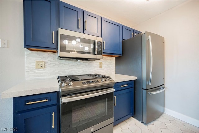 kitchen featuring backsplash, blue cabinets, light tile patterned floors, and appliances with stainless steel finishes