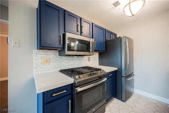 kitchen featuring backsplash, blue cabinets, stainless steel appliances, and light tile patterned floors