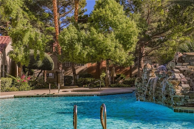 view of pool with pool water feature