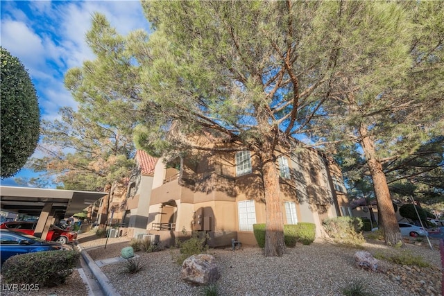 view of property exterior featuring a carport