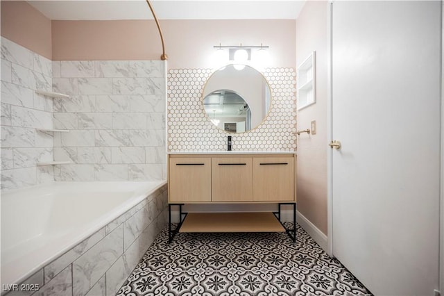 bathroom with vanity, tiled shower / bath combo, and tile patterned flooring