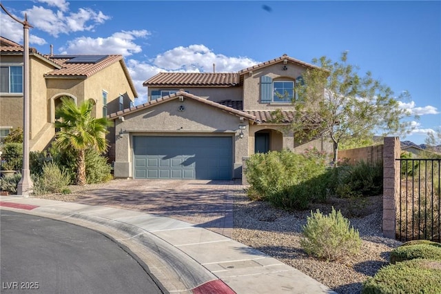 mediterranean / spanish-style home with a garage