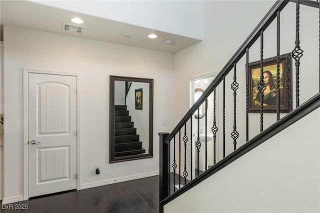 stairway with hardwood / wood-style flooring