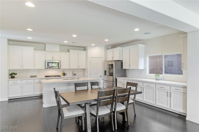 dining room with dark hardwood / wood-style flooring and sink