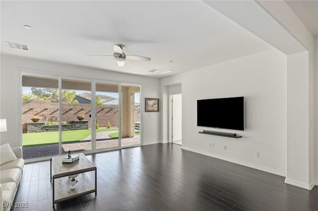 unfurnished living room with ceiling fan and dark hardwood / wood-style flooring