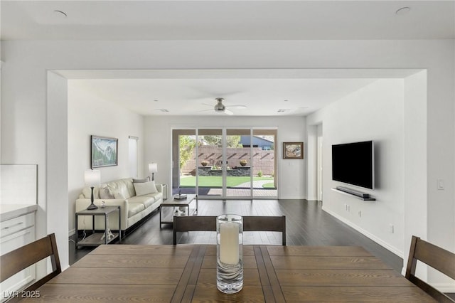 dining area with dark hardwood / wood-style floors and ceiling fan