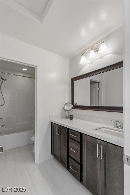 full bathroom featuring washtub / shower combination, tile patterned flooring, vanity, and toilet