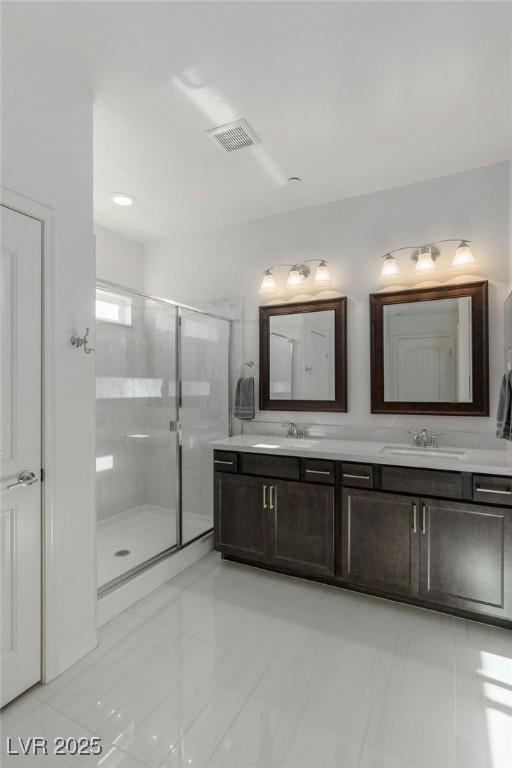 bathroom with tile patterned floors, vanity, and walk in shower