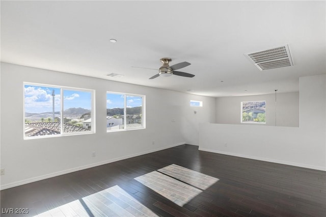 unfurnished room featuring ceiling fan and dark wood-type flooring