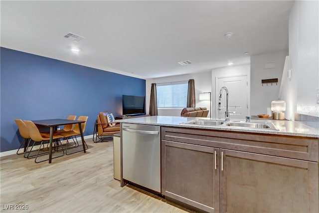 kitchen with dishwasher, light hardwood / wood-style flooring, and sink