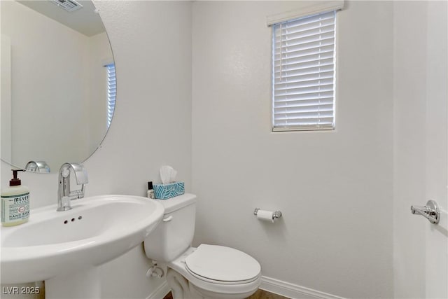 bathroom featuring toilet and sink