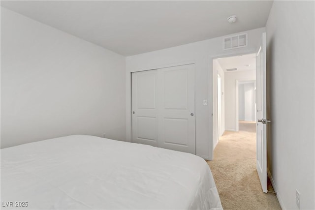 carpeted bedroom featuring a closet