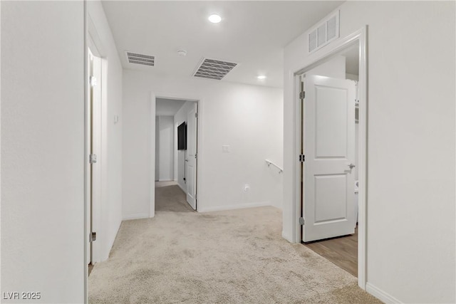 corridor with light colored carpet