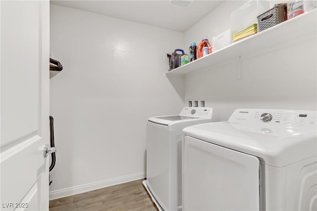 laundry area featuring washer and clothes dryer and wood-type flooring