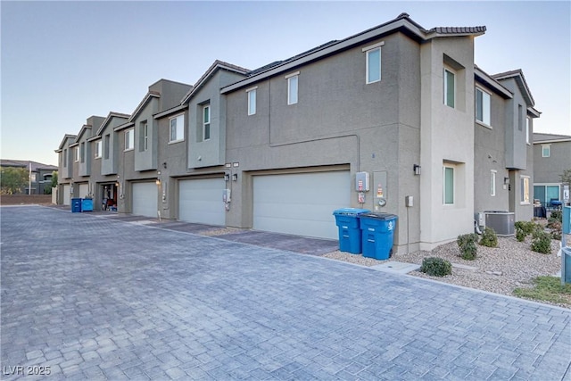 exterior space featuring a garage and central air condition unit