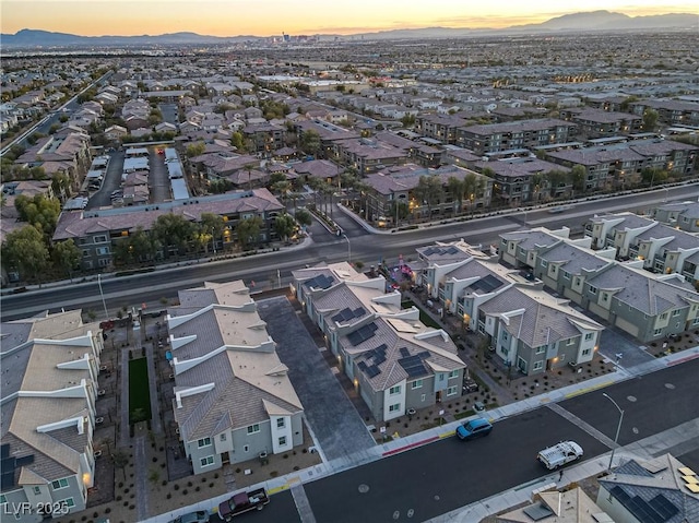 aerial view at dusk featuring a mountain view