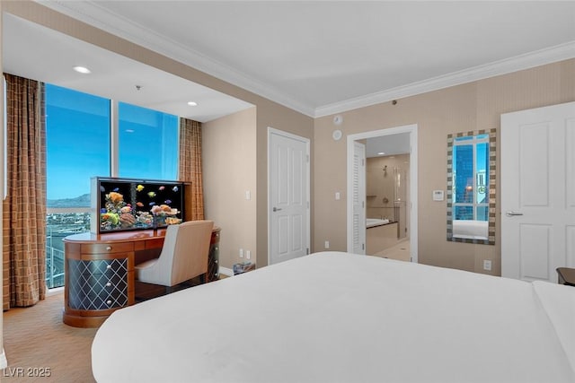 bedroom featuring connected bathroom and ornamental molding