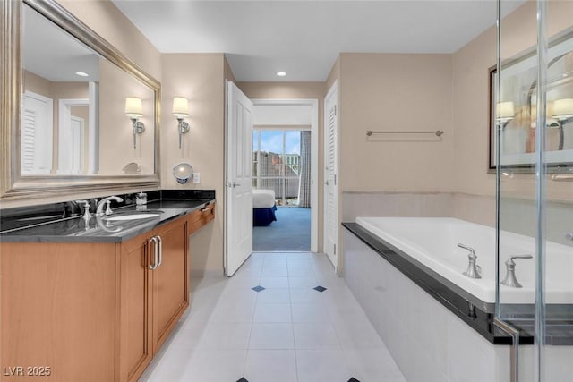 bathroom featuring tile patterned flooring, shower with separate bathtub, and vanity