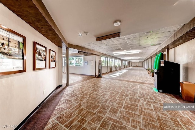 hallway featuring a drop ceiling