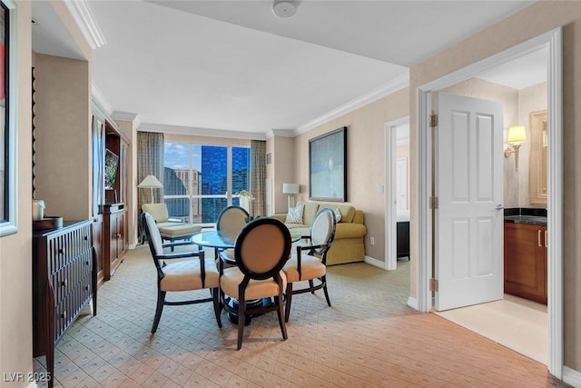 carpeted dining room with ornamental molding