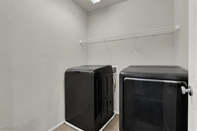 laundry area featuring laundry area, independent washer and dryer, and baseboards