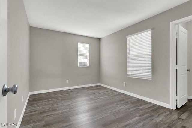 empty room with baseboards and wood finished floors