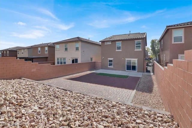 back of property with a patio area, a fenced backyard, a residential view, and stucco siding