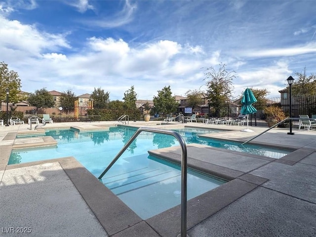 pool with fence and a patio