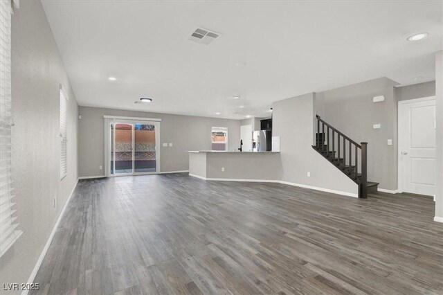 unfurnished living room featuring dark wood-type flooring