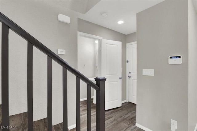 foyer with stairway, baseboards, and wood finished floors