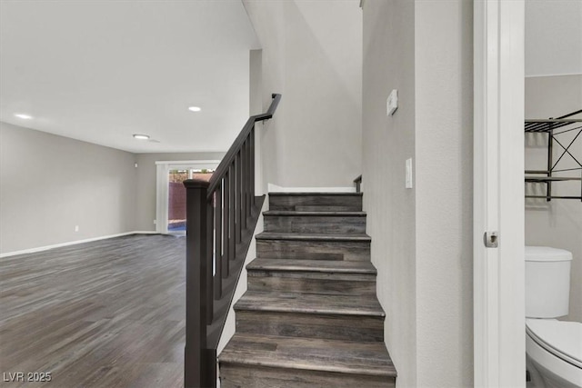 stairs with wood finished floors and baseboards