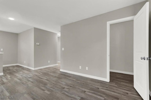 empty room featuring recessed lighting, baseboards, and wood finished floors