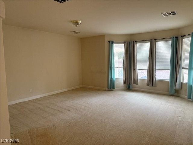 unfurnished room featuring light colored carpet