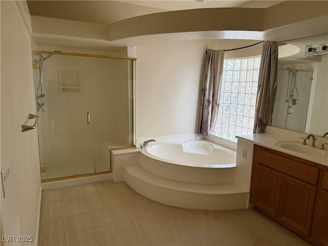 bathroom featuring vanity and separate shower and tub