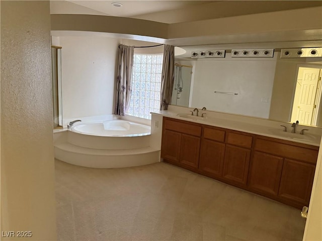 bathroom with vanity and a bath