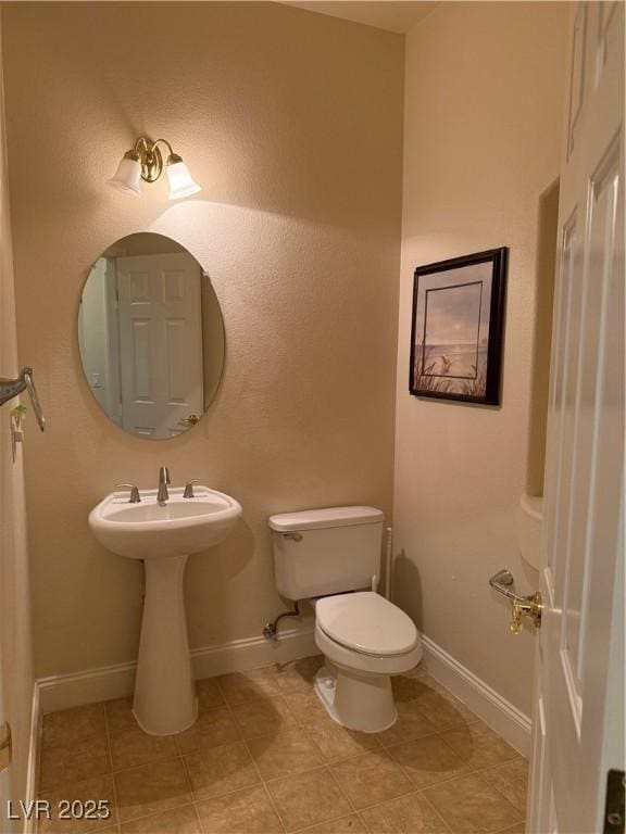 bathroom with tile patterned floors and toilet