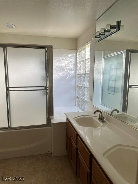 bathroom with vanity and shower / bath combination with glass door